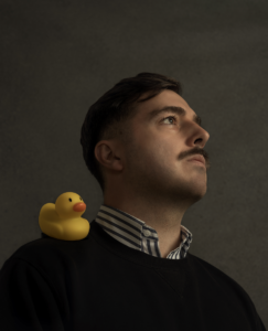 Price with a rubber duck on his shoulder