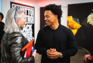 Ghetto Gastro author speaking with woman