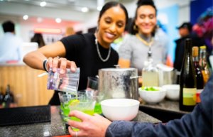 Bartender pours drink at gallery event