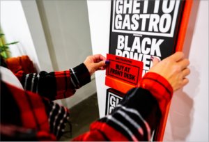 Hands placing Black Power Kitchen book on sale display