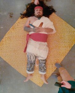 Josue about to be buried for gallery show