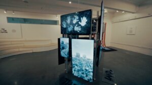 Video screens in a video screen sculpture show Josue's work.