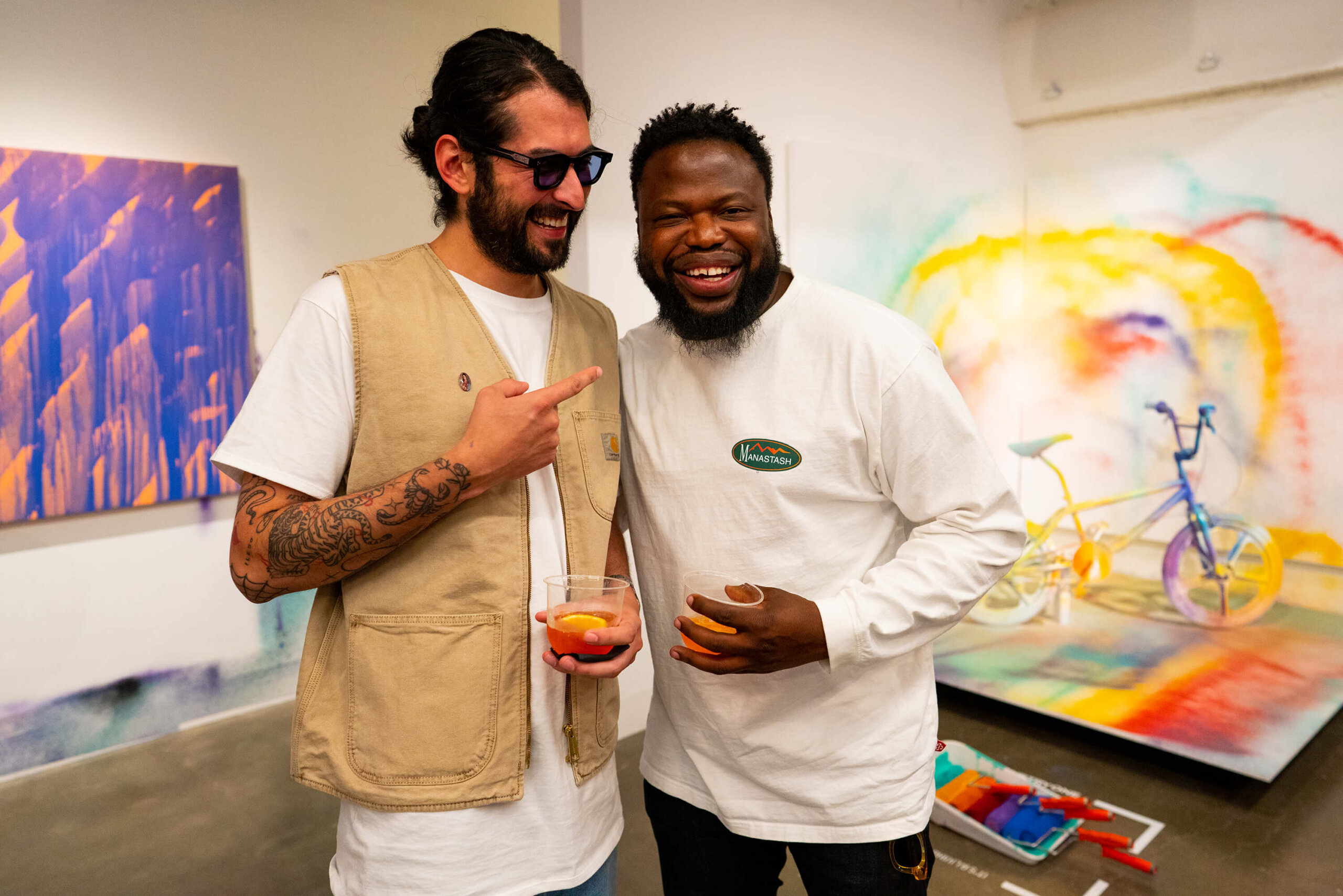 Its a Living poses with Exhibition attendee with drink in hand