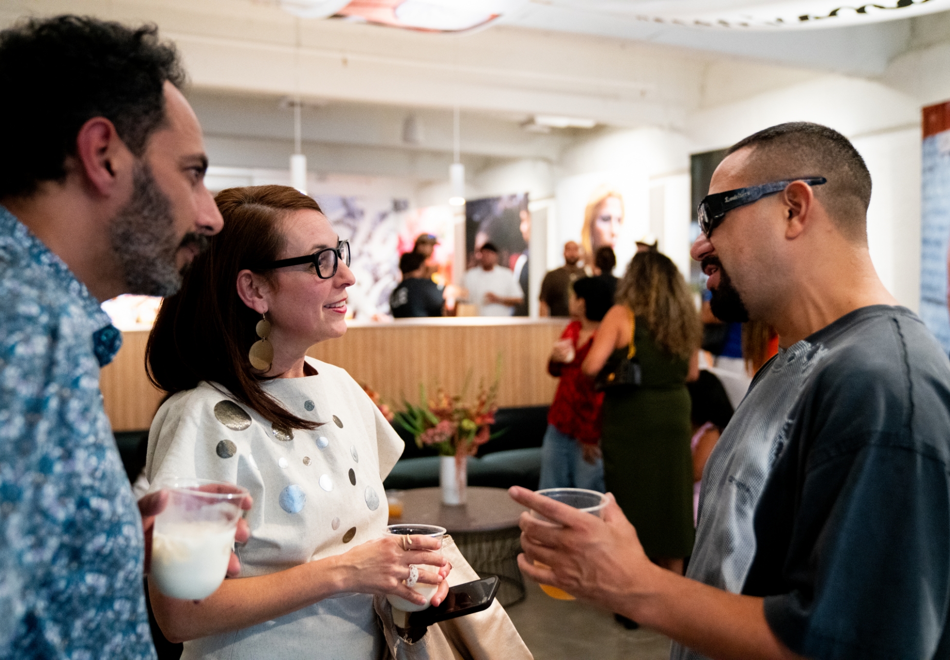 Dorian talks to two gallery show attendees