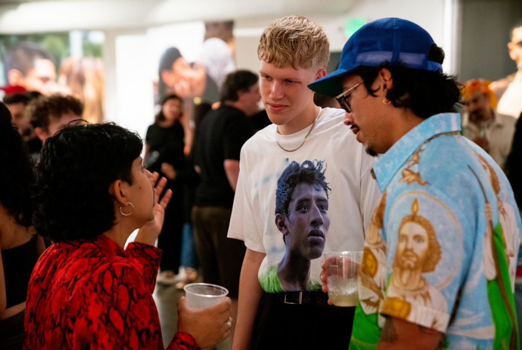 3 people talking together during the gallery show opening