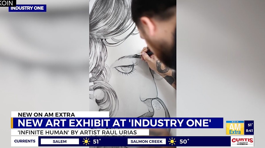 A person sketches a large, intricate, black-and-white drawing of a stylized human face with detailed hair. The image is featured on a news segment about a new art exhibit at "Industry One.