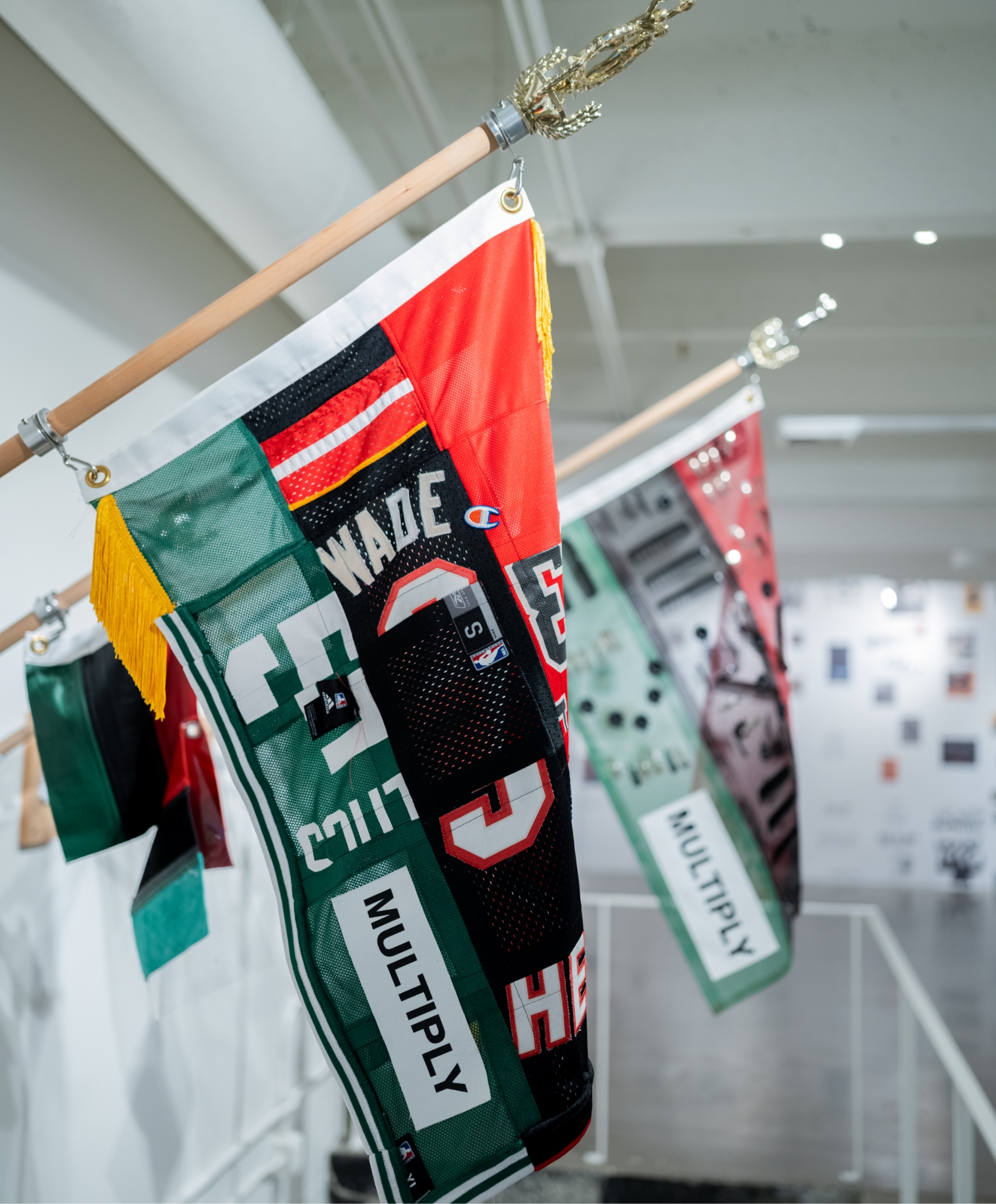 A group of flags hanging on a wall.