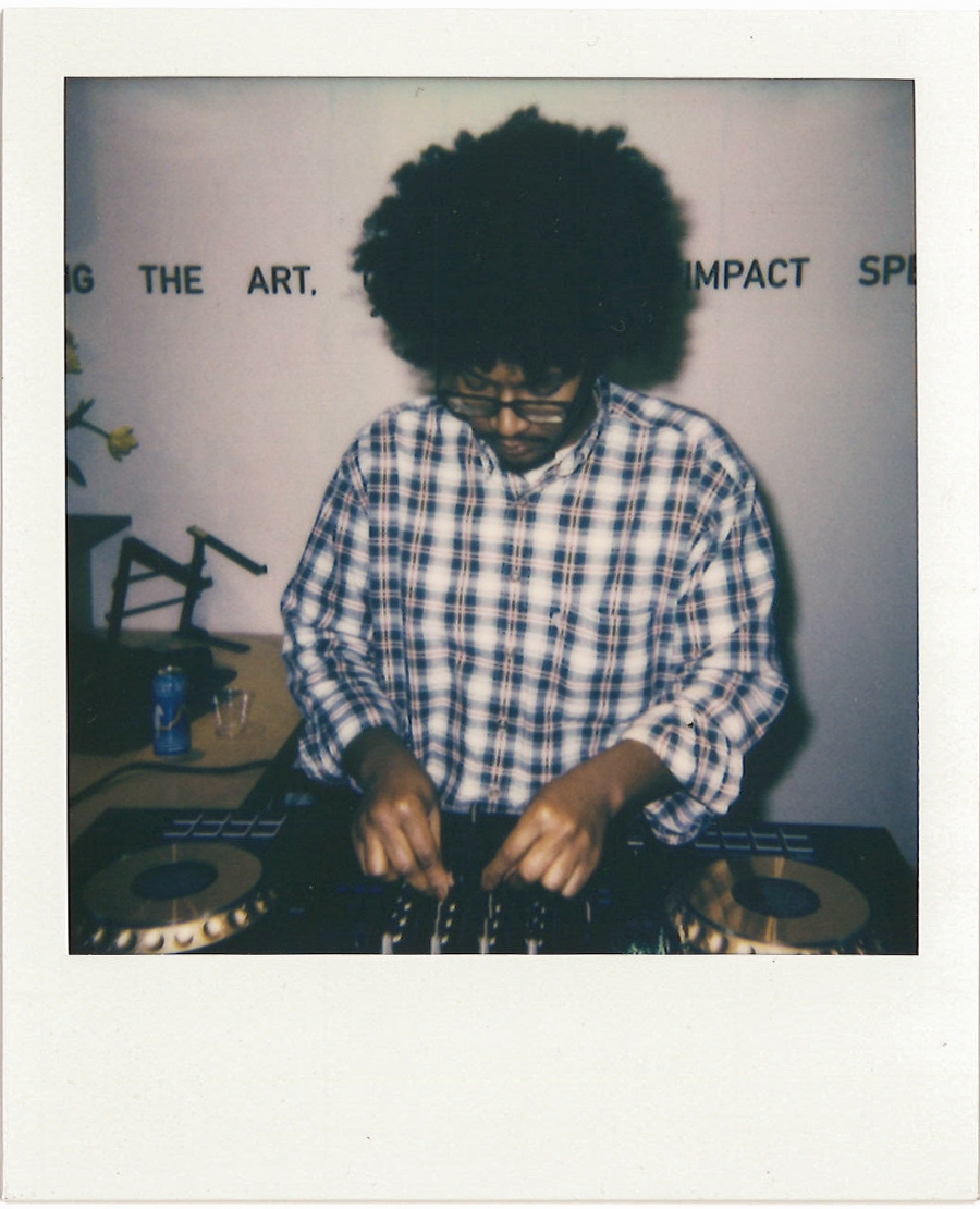 polaroid of DJ adjusting knobs on mixer
